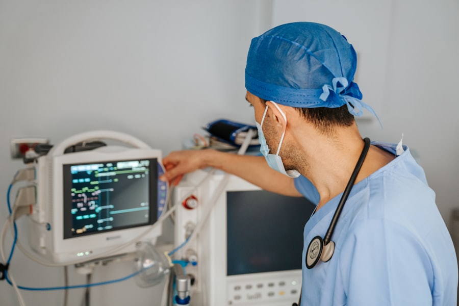 Clinician reviewing a patient monitor in an intensive care unit
